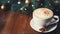 Christmas coffee cup with fir branches and copy space on background. Winter latte, hot drink. Cozy atmosphere. Christmas