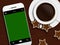 Christmas coffee, gingerbread and mobile phone lying on wooden t