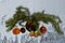 Christmas collage: decorated fir branches, tangerine, pine cone, walnuts