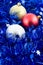 Christmas colored balls in blue tinsel