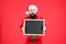 Christmas is coming. Hipster hold santa wish list blackboard. Bearded man with blank advertising blackboard. Blackboard