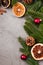 Christmas composition. Balls, cinnamon, anise, dried fruits, pine cones and fir needles decorations on grey background