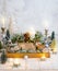 Christmas composition of candles, deer, pine cones, christmas baubles, fir branches, flowers, moss, winter berries in wooden box.