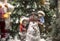 Christmas composition: children and a snowman in the forest. New Year`s decor.