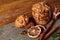 Christmas composition with chocolate biscuits, cinnamon and dried oranges on wooden background, close-up.