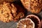 Christmas composition with chocolate biscuits, cinnamon and dried oranges on wooden background, close-up.