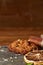 Christmas composition with chocolate biscuits, cinnamon and dried oranges on wooden background, close-up.