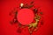 Christmas composition. Christmas gold and red decorations on a red background. Place for text