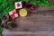 Christmas composition. Christmas present, pine cones, fir branches on a wooden background