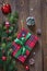 Christmas composition. Christmas tree branches and red gift box on the old wooden table