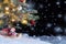 Christmas composition - Christmas tree in the snow, gifts, toy snowman and the inscription Merry Christmas and Happy New