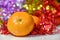 Christmas composition on colorful bokeh background. Mandarins against a background of blurry defocused multicolored lights and tin