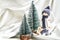 Christmas composition with doll skiing and fir trees festive decorations on silk. Christmas or New Year greeting card