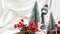 Christmas composition with doll skiing and fir trees festive decorations on silk. Christmas or New Year greeting card