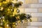 Christmas composition in the evening illumination of lighted garlands. Xmas fir tree with baubles, multi-colored bows, animals,