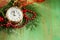 Christmas composition with fir branches, decorations and clock