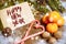 Christmas composition with fir tree branch, envelope, candy cane and tangerines on wooden background