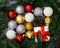 Christmas composition with fir tree, gift, cones and balls. White wood plank background.