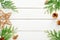 Christmas composition. Frame made of Christmas decorations and fir tree branch on wooden white table. Flat lay, top view, copy