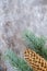 Christmas composition: Fresh branches of blue spruce with cones on aged wooden background. Top view