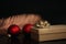 Christmas composition. Gift and red decoration on the black background. Modern Xmas background.