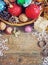 Christmas Composition with Gifts. Basket, red balls, pine cones, snowflakes on Wooden Table. Vintage style