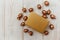 Christmas composition.Golden present box and golden acorns.White wooden table