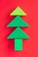 Christmas composition kids. Christmas tree made from green wooden construction blocks against red background. Children\\\'s colorful