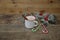 Christmas composition with mug of cocoa, caramel canes and decorations on wooden background with copy space for text.