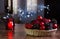 Christmas composition with pine cones, red balls and candle with bokeh lights behind