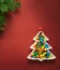 Christmas composition. A plate in the shape of a Christmas tree filled with colorful candies. Branches of spruce on a
