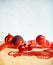 Christmas Composition. Red Baubles, Ribbon And Chain On Bright Background.