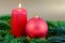 Christmas composition with red candle, Christmas ball and fir br