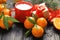 Christmas composition with ripe tangerines, cup of hot drink and gift box