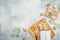 Christmas composition with stollen cake on a wooden board, cutlery and gift on gray background. Flat lay