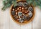 Christmas composition.Tree banches,white cones and golden acorns in the wooden plate