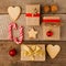 Christmas composition of various gift boxes wrapped in craft paper and decorated with satin red gold ribbons and holiday sweetness