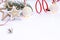 Christmas composition of wooden stars with sparkles, garlands of white luminous balls, fir branches and red ribbons on a