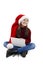 Christmas computer little girl holding notebook laughing wearing santa hat. Beautiful little girl smiling sitting on floor,