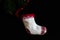 Christmas concept. Christmas decorations on black background. Small Christmas sock