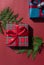 Christmas concept composition with tartan pattern gift box on the red background.