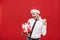 Christmas Concept - portrait happy Santa christmas businessman exciting with his gift over red background.