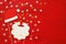 Christmas concept top view image. Santa claus beard and hat on red wooden background