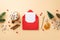 Christmas concept. Top view photo of open envelope with card pen wood ornaments pine branch cone mug of cocoa mistletoe dried