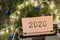 Christmas concept - typewriter with text "2020", spruce branches and garland