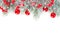 Christmas concept. Xmas border composition with red glass baubles, holly berries and green fir branch isolated on white background