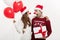 Christmas Concept - Young caucasian couple holding gifts,champagne and balloon making funny face on Christmas