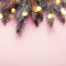 Christmas coniferous border with cones and bokeh lights. Pink background