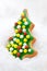 Christmas cookie, glazed christmas tree shape on a snow