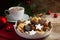 Christmas cookies and a coffee cup with hot cocoa, fir tree bran